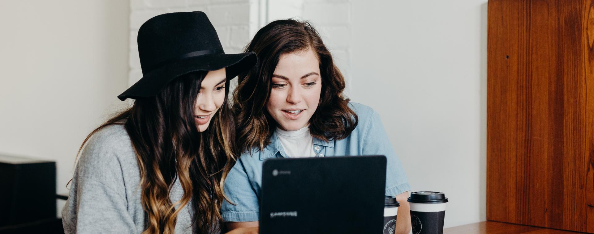 young women in front of computer